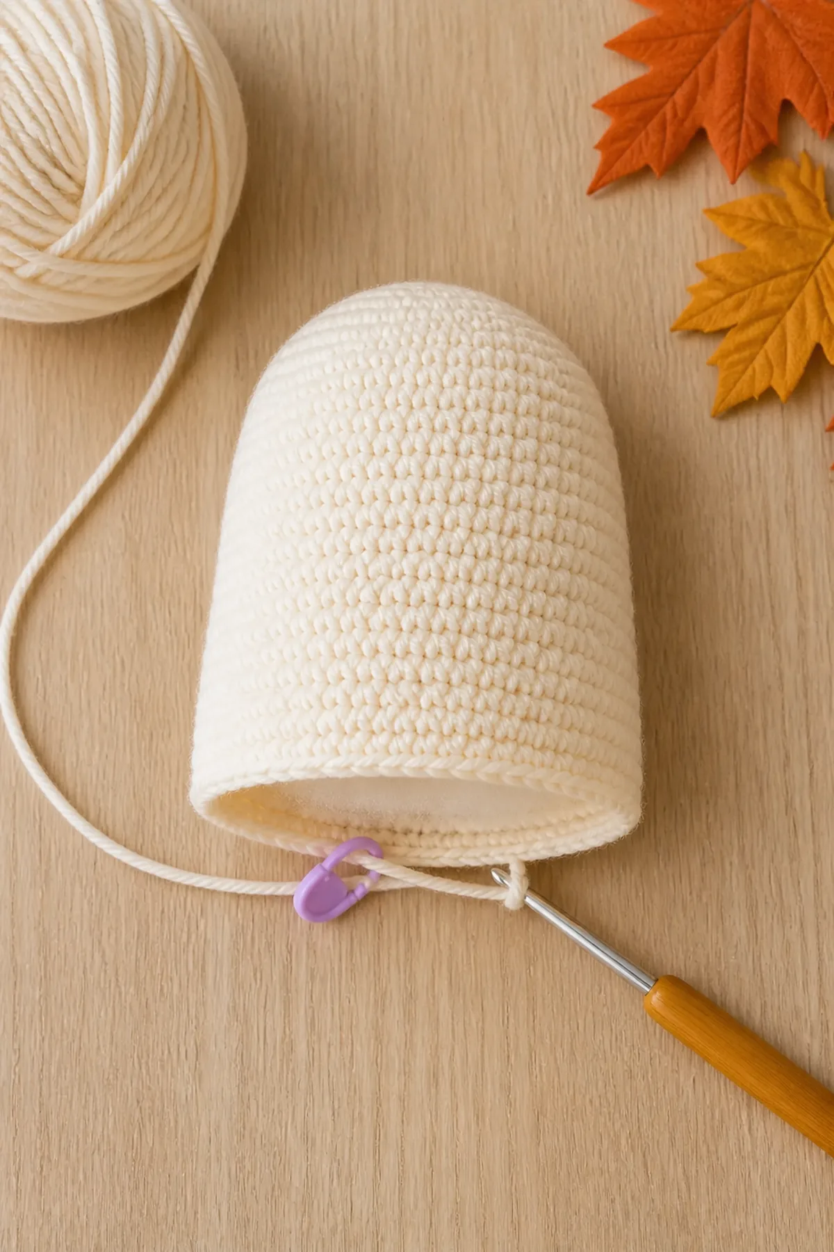 Partially stuffed cream crochet ghost body with an open lower edge and active hook