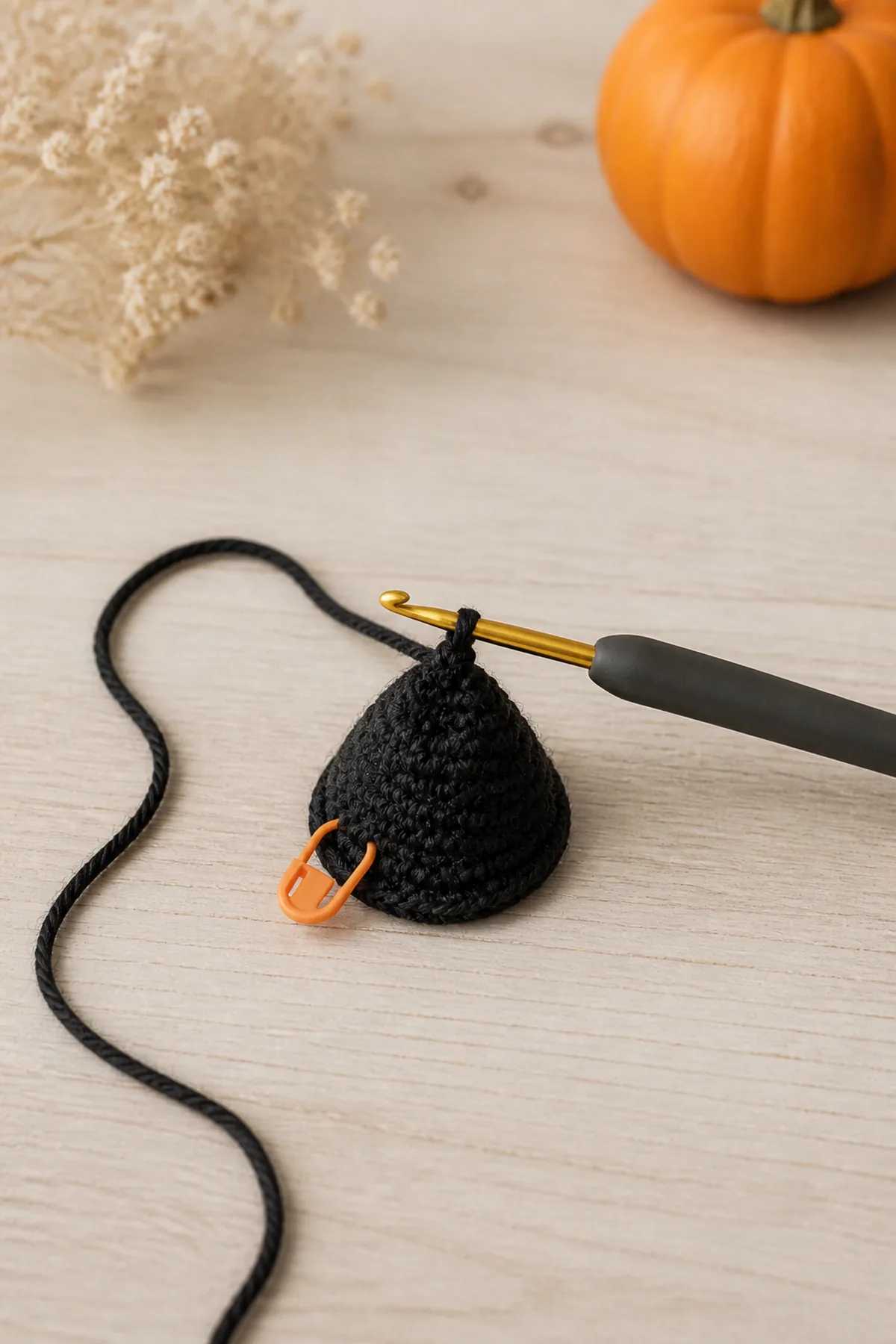Small charcoal crochet cone growing from a marked magic ring