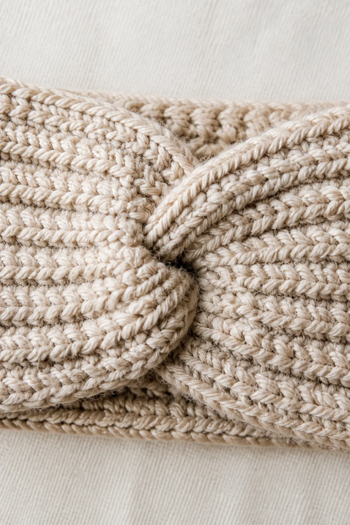 Close-up of crochet stitches and finishing details in oatmeal neutral