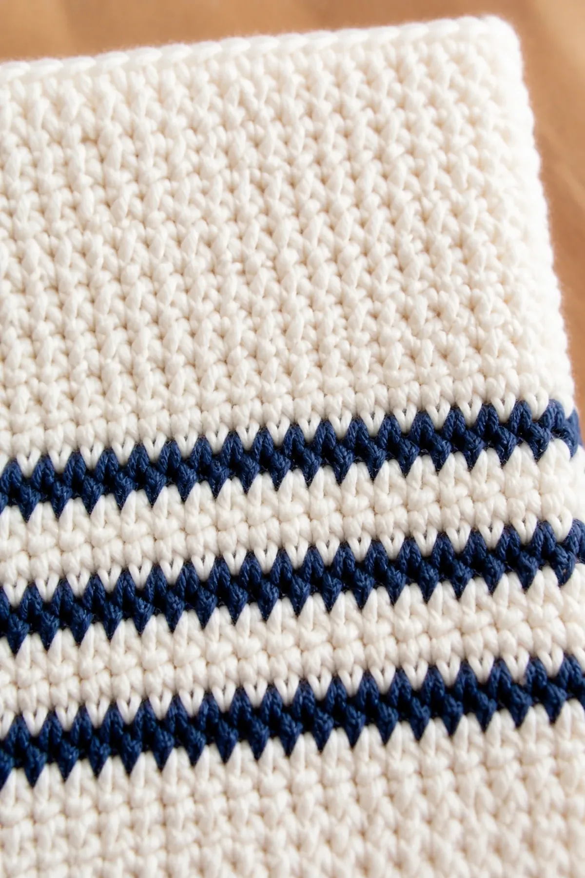 Close-up stitch detail on the ivory and navy striped farmhouse dishcloth