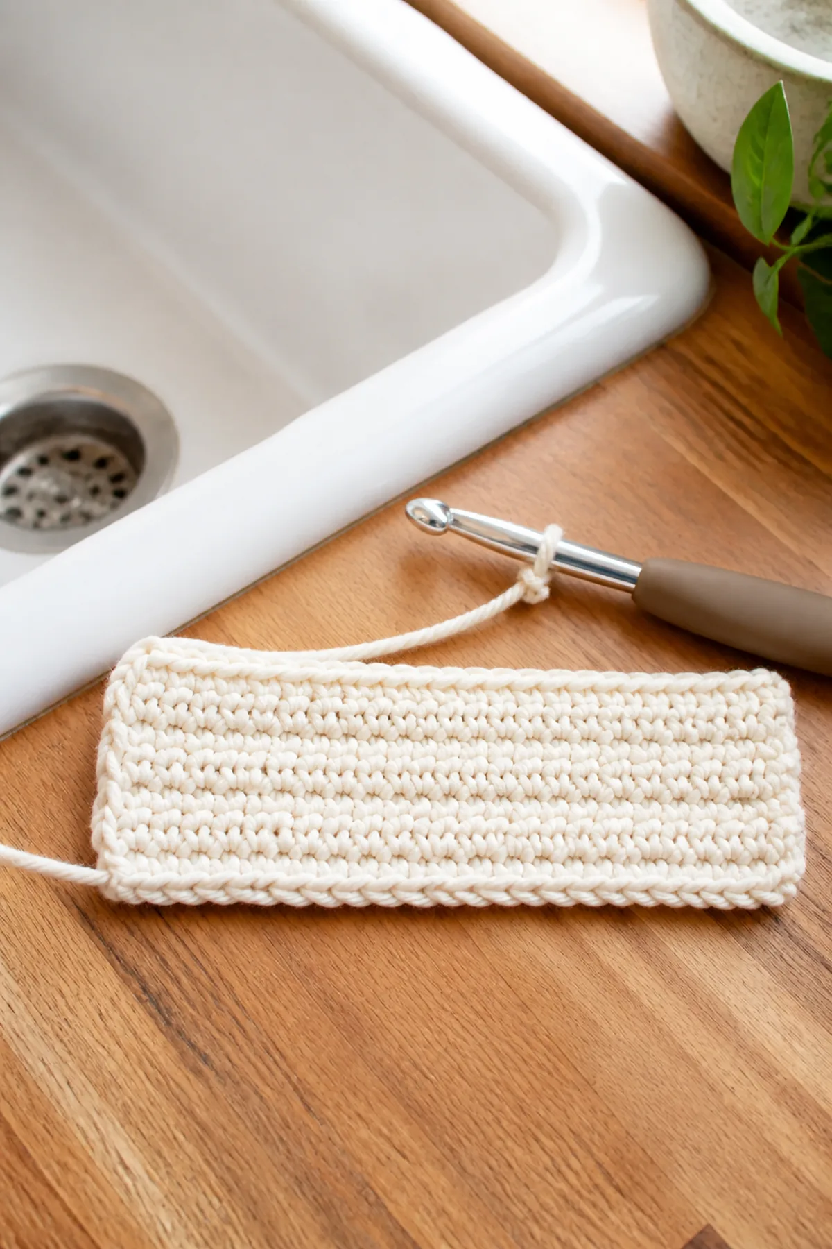 Early construction of the ivory and navy striped farmhouse dishcloth