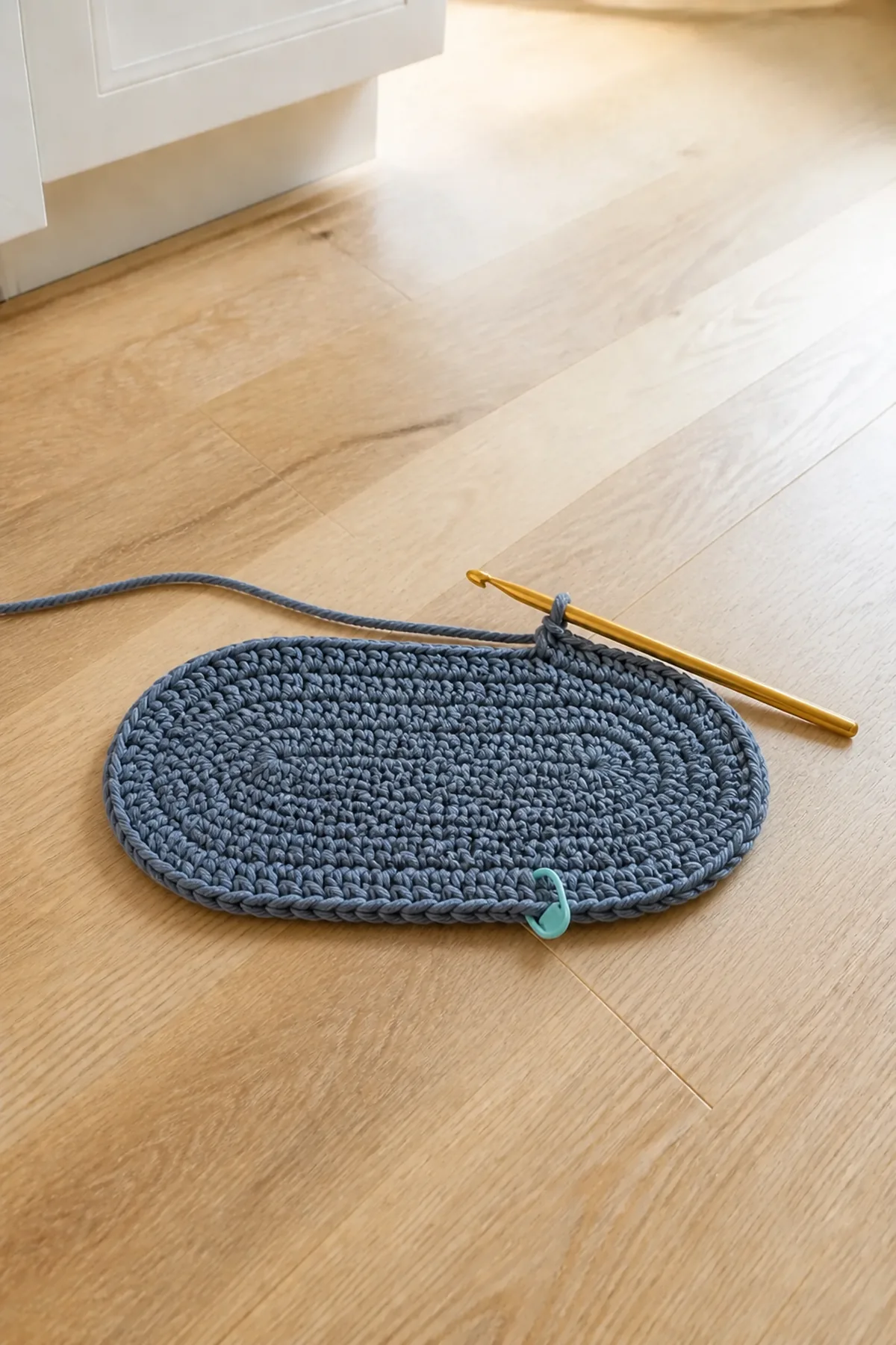 Early construction of the slate blue oval pet bowl mat with cream border
